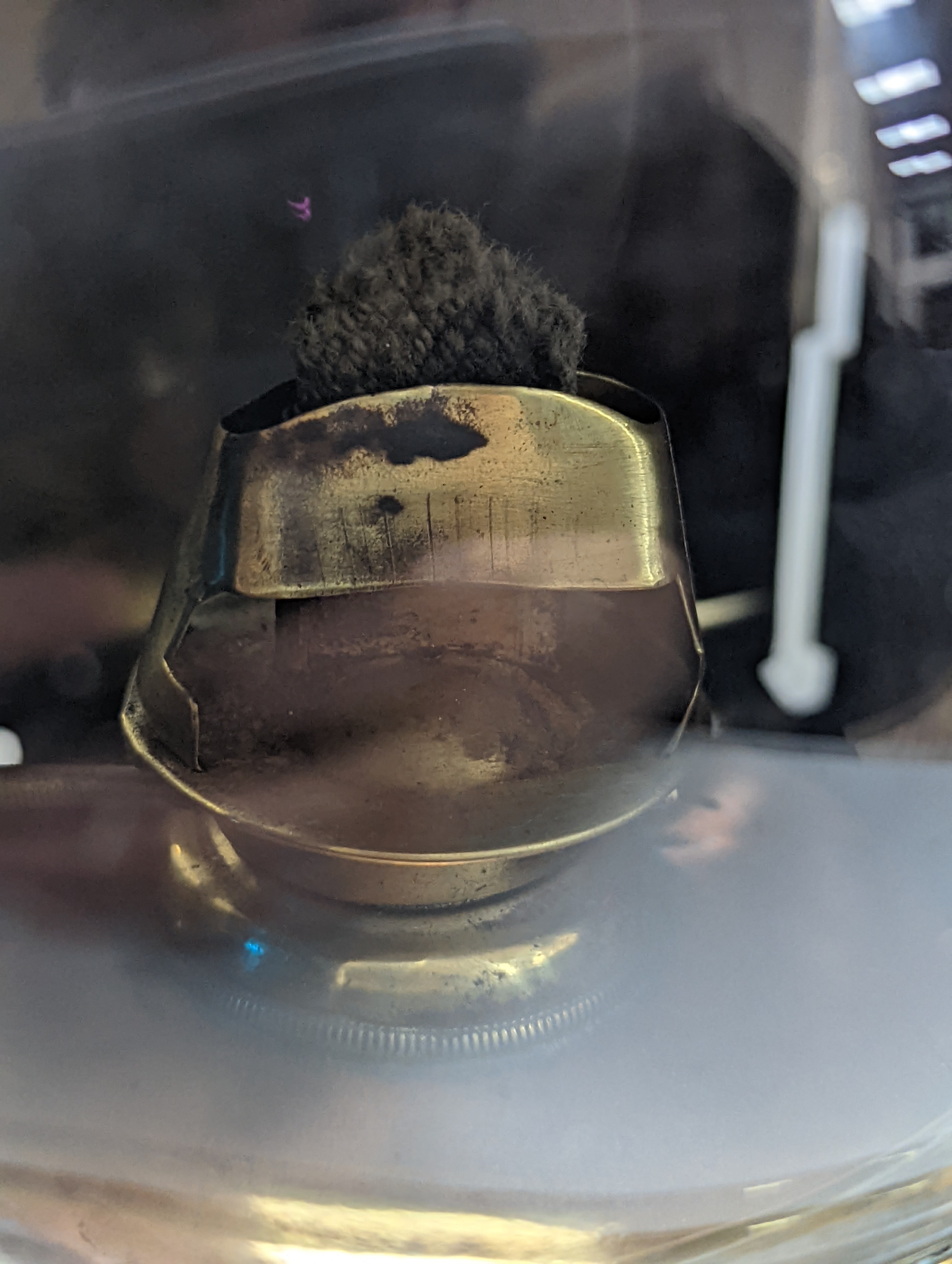 A copper ship's binnacle compass, a brass oil lamp, a brass jug and a copper kettle